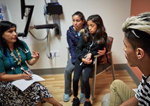 Doctor meets with family at community health center.