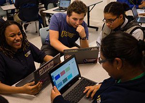 Group of charter high school students work on their laptops.