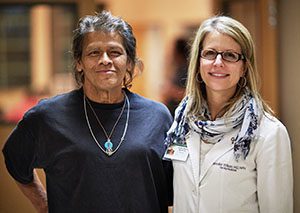 Ole Health doctor poses with patient.