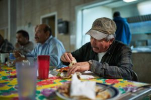 Men eat in a farmworkers' center in California.