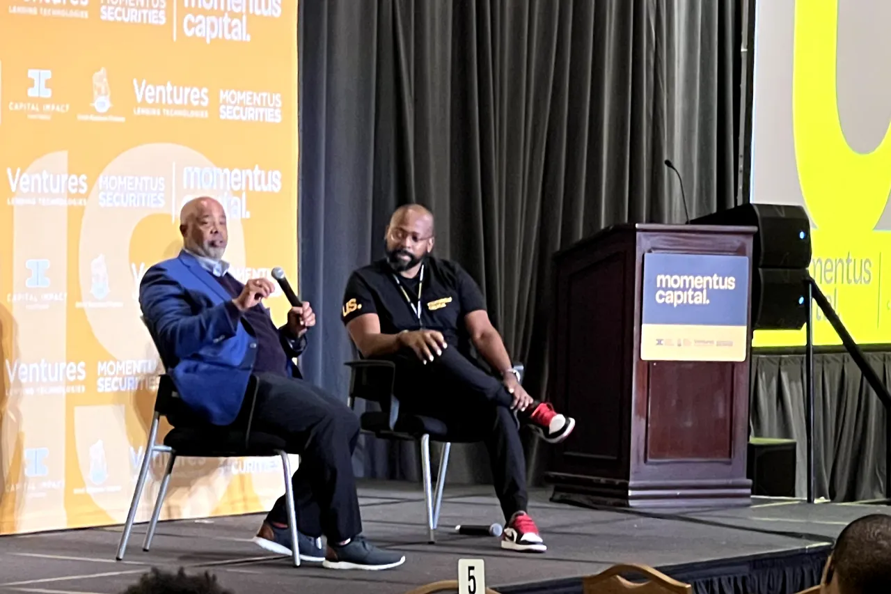 Ellis Carr and Gary Cunningham discuss the need to disrupt the financial sector to support equity and inclusion at the Momentus Capital All Staff meeting.